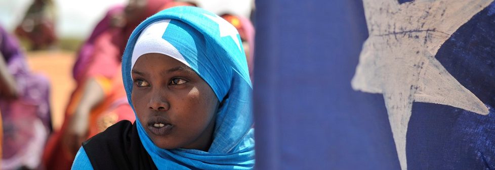 A young woman holds the Somali flag. PHOTO / Tobin Jone