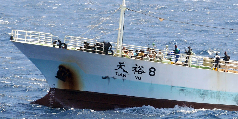 Pirates holding the crew of the Chinese fishing vessel FV Tianyu 8 guard the crew Monday, Nov. 17, 2008, as the ship passes through the Indian Ocean.