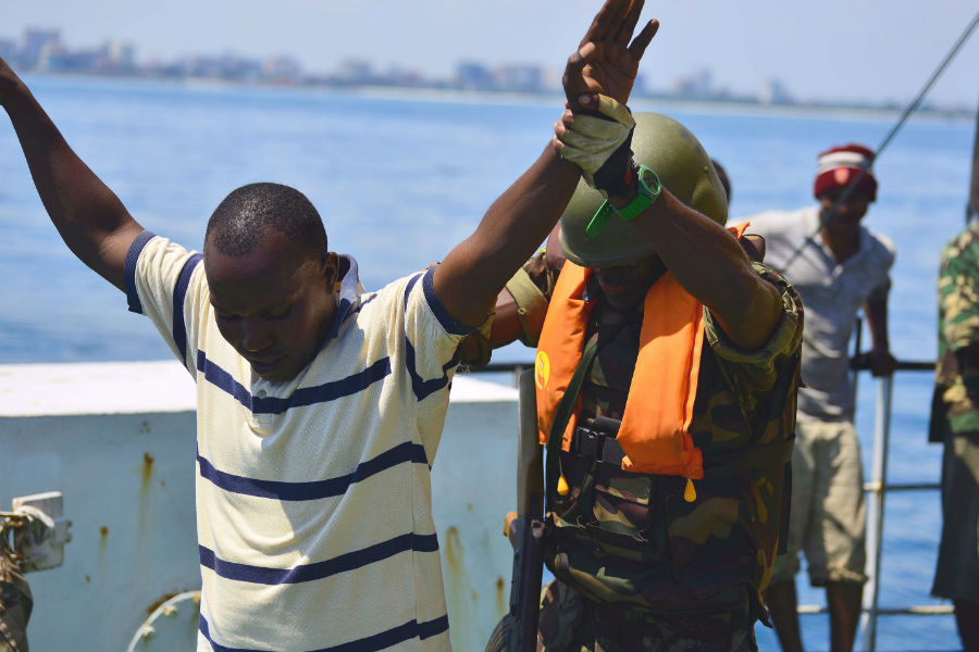 An Armed Forces for the Defence of Mozambique boarding team member searches a simulated illegal fisherman during Exercise Cutlass Express 2013. (Photo: US Air Force/Tech. Sgt. Chad Thompson.)