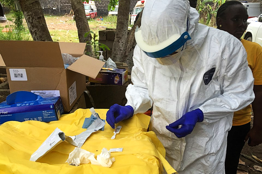 Disease detectives conducting testing out in the field during the 2014 Ebola outbreak in Liberia.