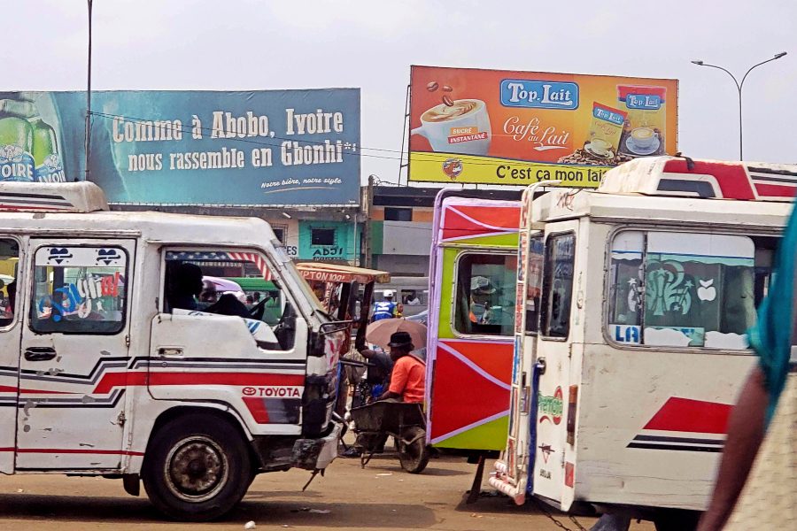 Gbaka buses line a busy street in Abobo