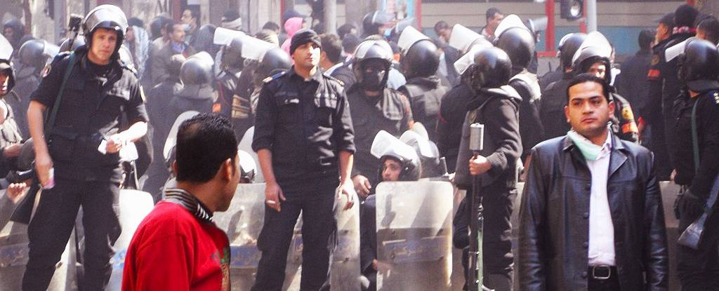 An Egyptian protester facing a state security officer.