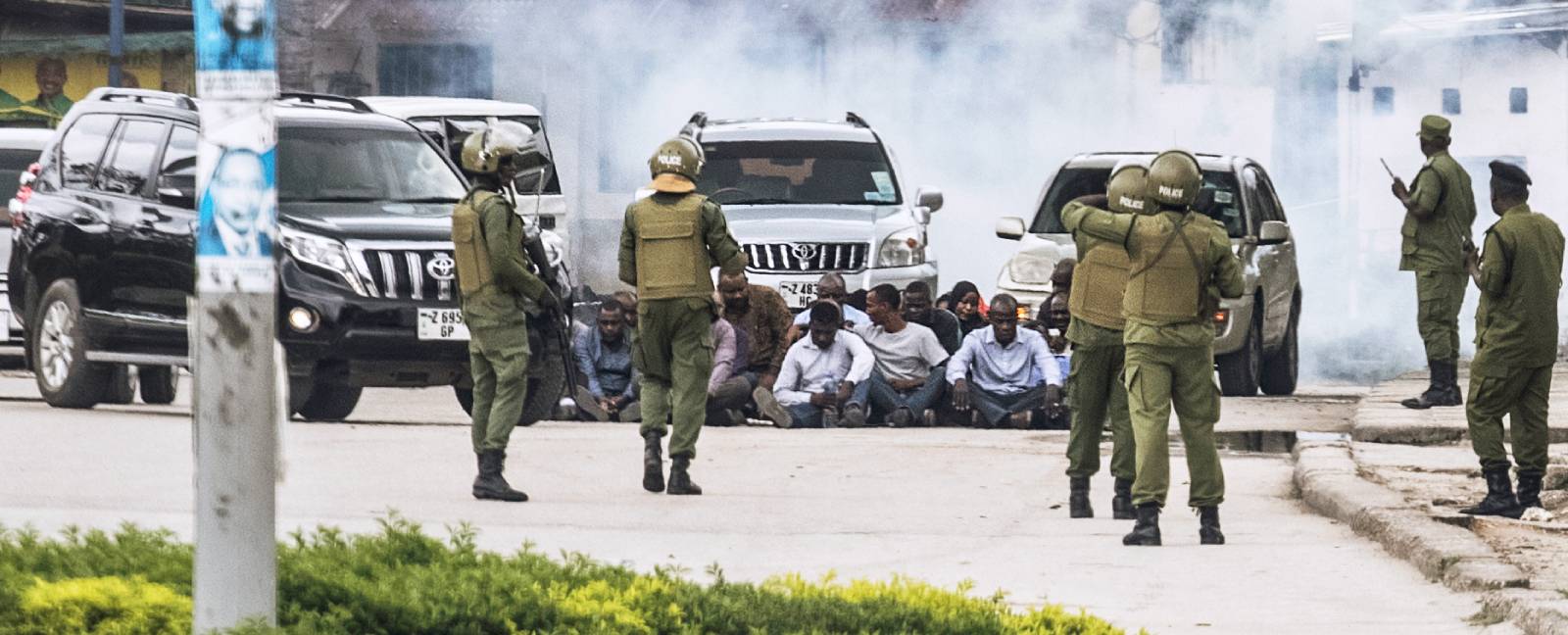 Anti-riot police in Zanzibar guarding a group of men during opposition protests the day after the 2020 presidential election. (Photo: AFP)
