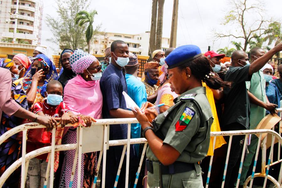 A Nigerian police officer taking notes during a protest by Muslim pilgrims
