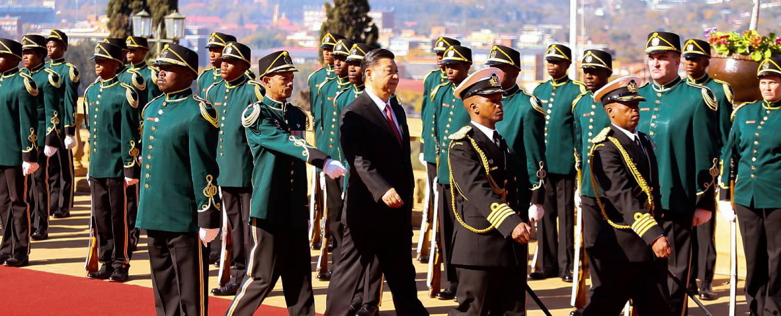 Xi Jinping inspects a military honor guard in Pretoria South Africa.
