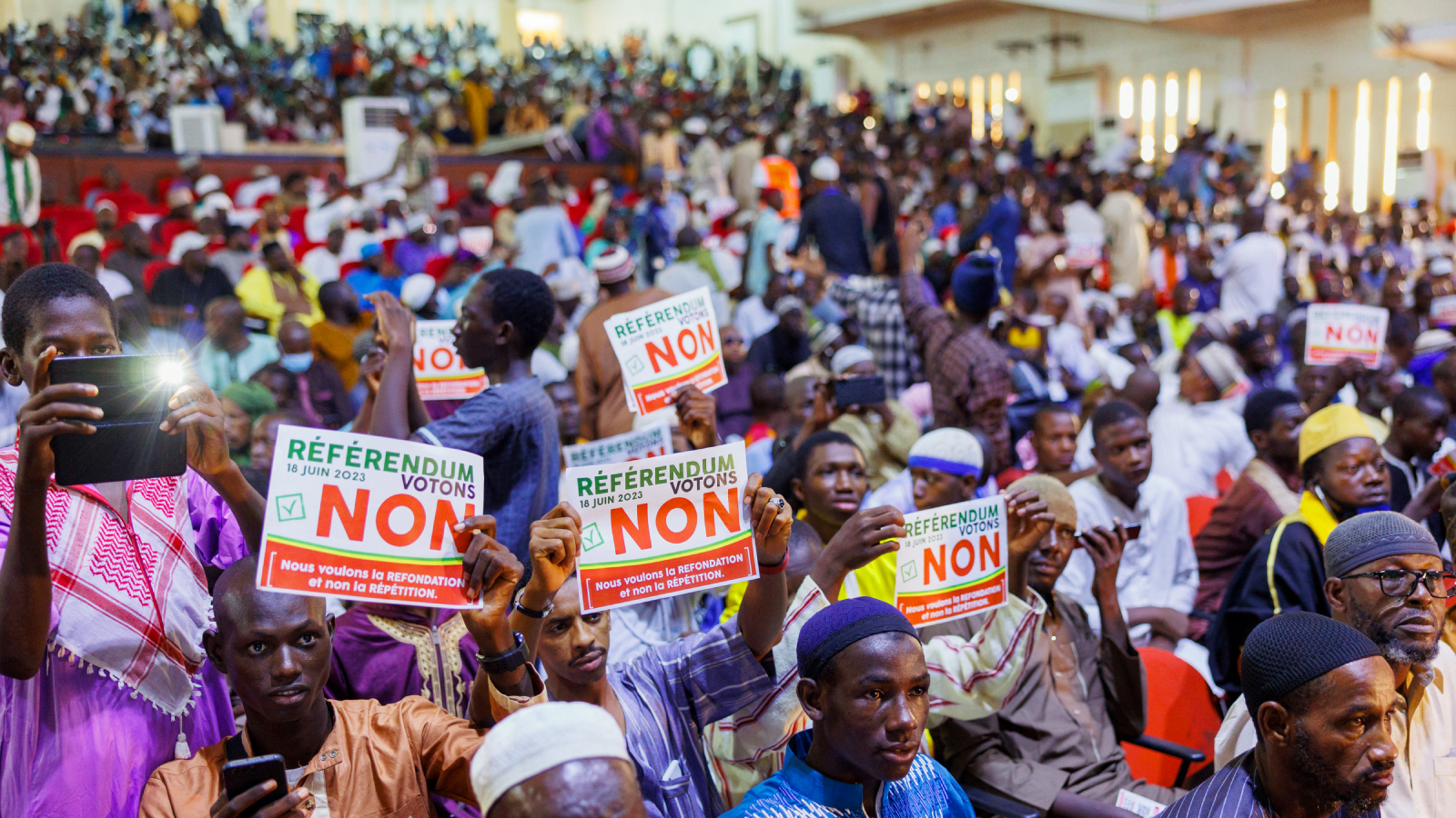 People hold up signs that read "vote no in the referendum" during a march in Bamako, Mali.