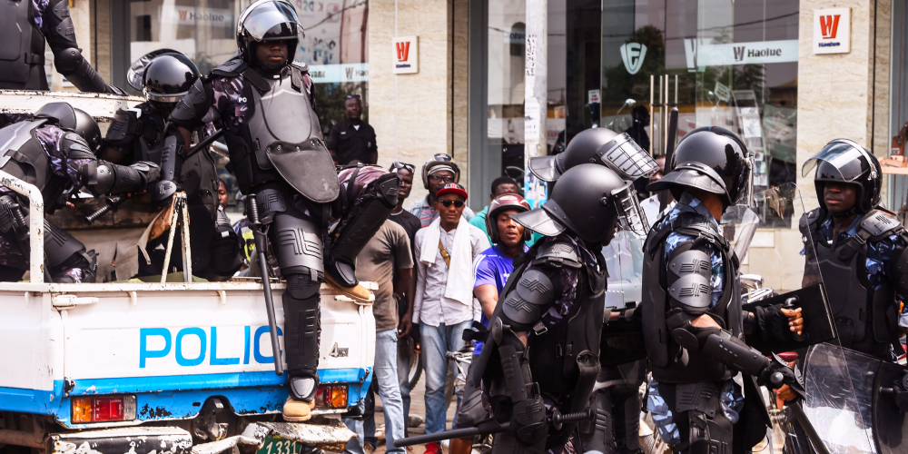 Anti-riot policemen warn protesters in Lomé
