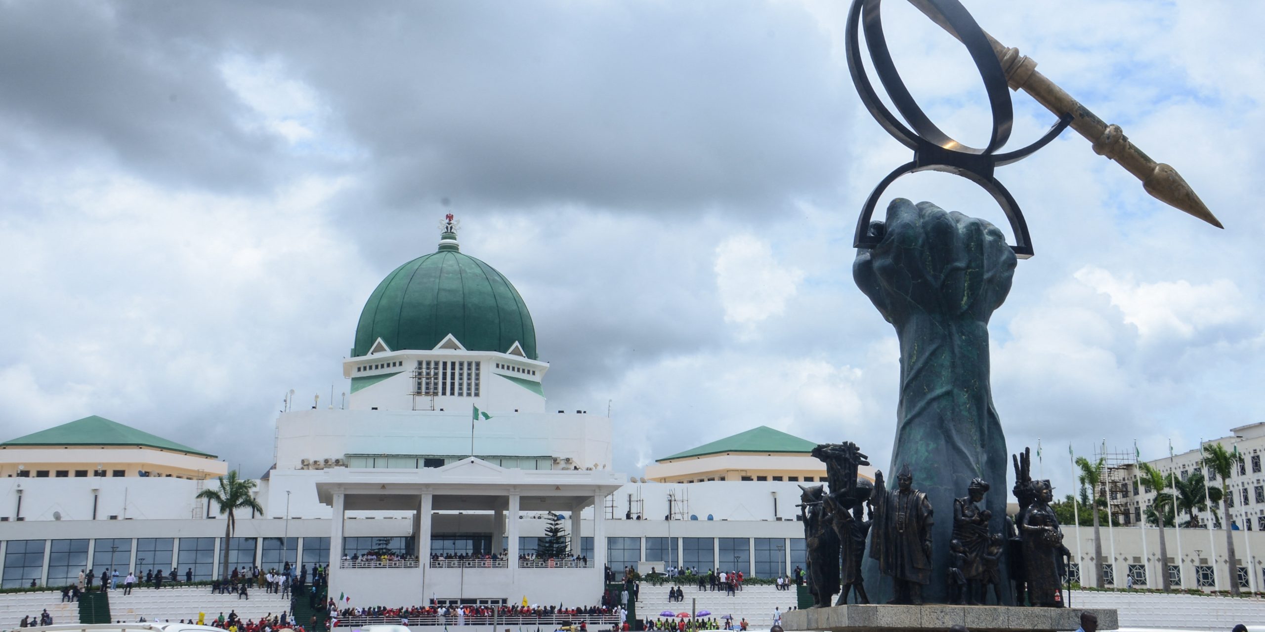Sculpture of a powerful forearm holding a mace in front of the National Assembly of the Federal Republic of Nigeria symbolizes the authority of the legislature on behalf of the people.