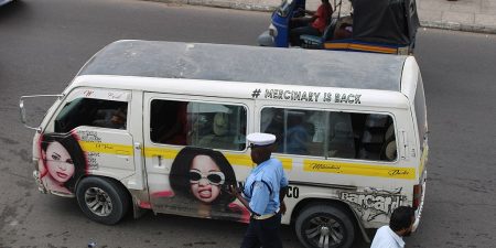 A police officer inspects a matatu, a public minibus in Kenya.