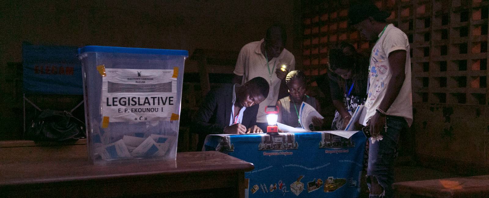 Electoral officials count votes after the general and municipal elections in Yaounde.