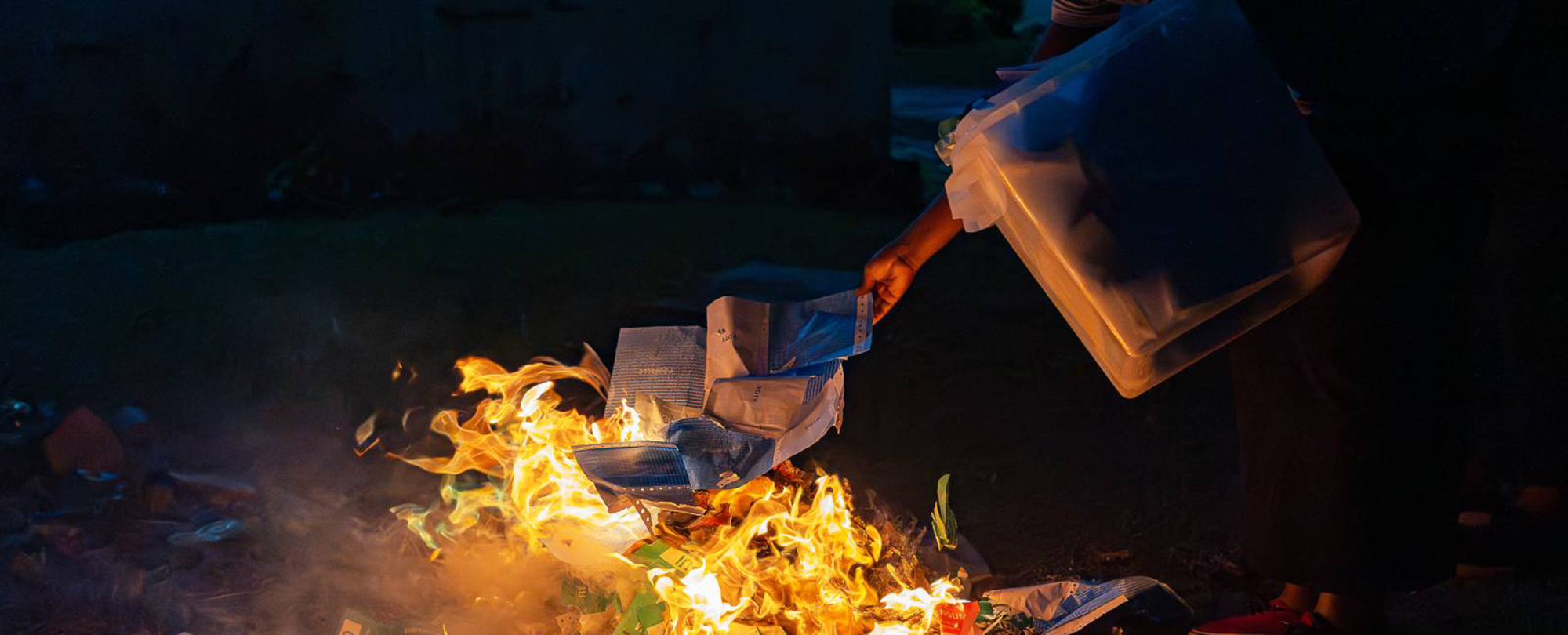 An election official burns ballots after the counting has finished at a voting station in Libreville on November 16, 2024. (Photo: AFP/Nao Mukadi)