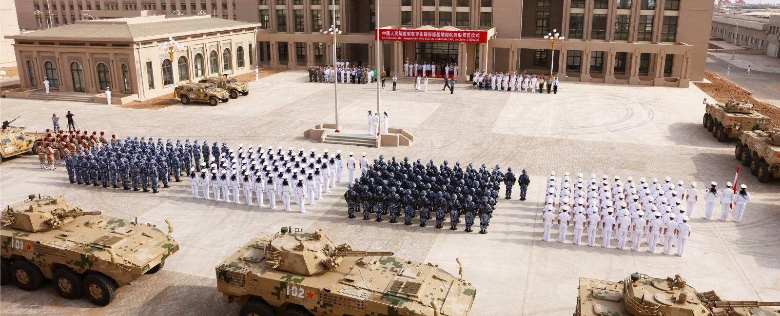 Ranks of troops and tanks arrayed before the main building of China's military base in Djibouti.