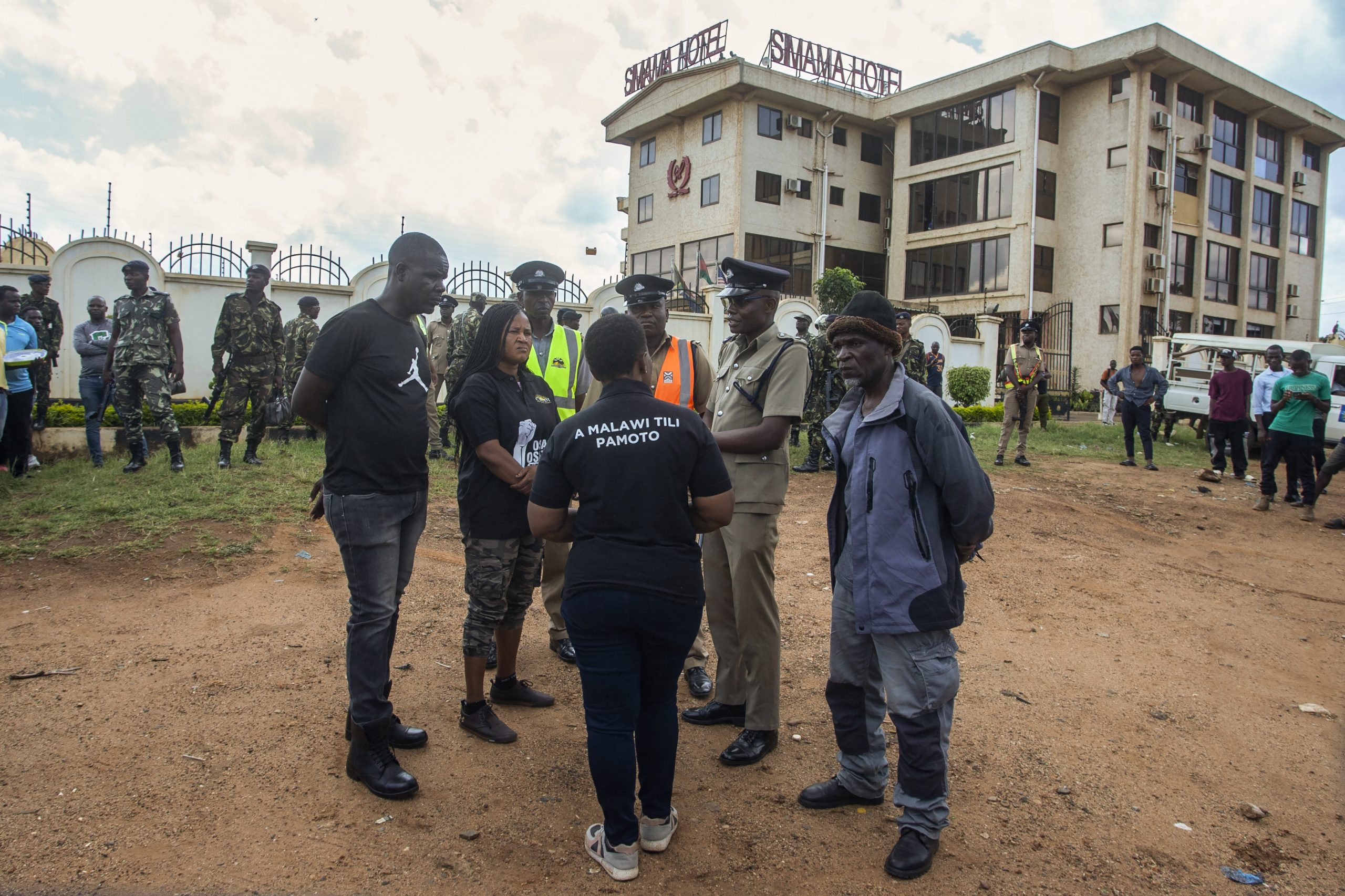 Demonstrators speak with police officers during a demonstration in Lilongwe, Malawi. Demonstrators speak with police officers during a demonstration in Lilongwe, Malawi.