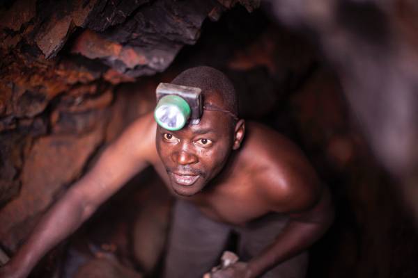 DRC miner An artisanal miner looks out from a tunnel in a mine near Bukavu, DRC.