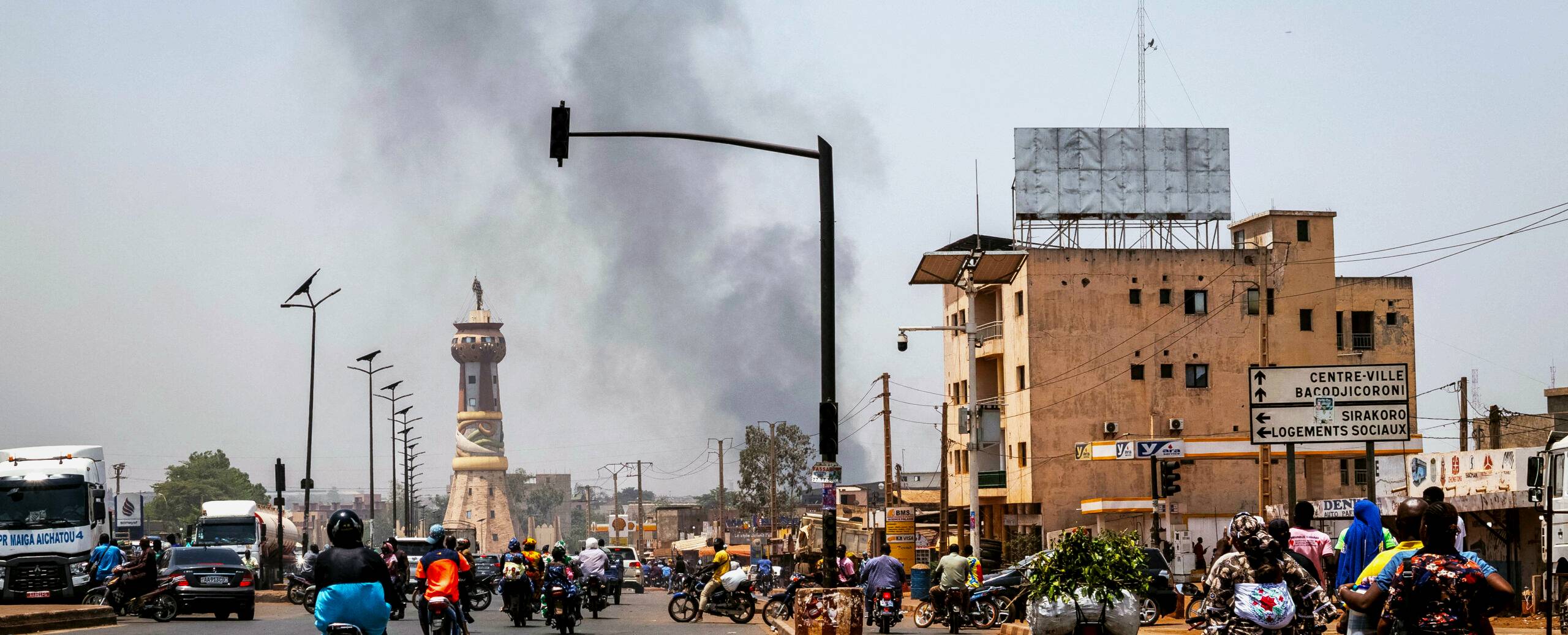 A column of black smoke rises above buildings in Bamako in the aftermath of the April 25 attacks.